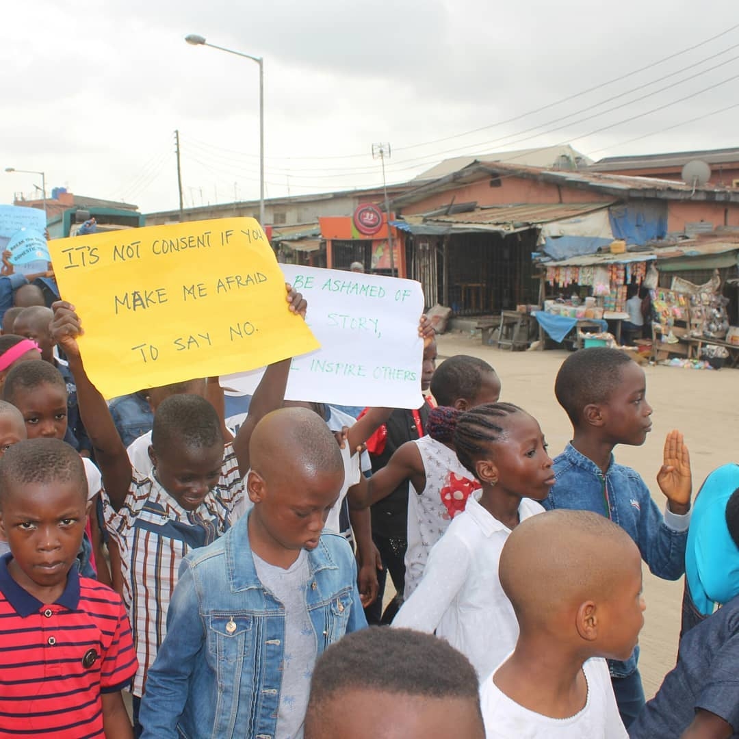 Children at an OLIC mental health rally carrying placards